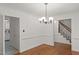 Dining room with hardwood floors adjacent to kitchen and stairs at 10836 Wilmore Dr, Raleigh, NC 27614