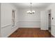 Hardwood dining room featuring natural light and a classic chandelier at 10836 Wilmore Dr, Raleigh, NC 27614