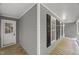 Welcoming covered porch featuring grey siding, black shutters, and wood flooring at 10836 Wilmore Dr, Raleigh, NC 27614