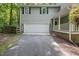 Exterior view of the home featuring an attached two-car garage and a paved driveway at 10836 Wilmore Dr, Raleigh, NC 27614