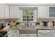 Close-up of a kitchen featuring granite countertops and a farmhouse sink at 10836 Wilmore Dr, Raleigh, NC 27614