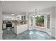 Bright kitchen with white cabinetry, granite counters, and a bay window eating nook at 10836 Wilmore Dr, Raleigh, NC 27614