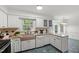 Well-lit kitchen featuring granite countertops and a farmhouse sink overlooking the backyard at 10836 Wilmore Dr, Raleigh, NC 27614