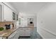 Cozy kitchen featuring granite countertops, white cabinets, and views of living area at 10836 Wilmore Dr, Raleigh, NC 27614