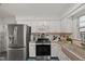 Well-appointed kitchen featuring stainless steel appliances, white cabinets, and granite counters at 10836 Wilmore Dr, Raleigh, NC 27614
