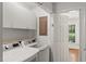 Convenient laundry room features a washer, dryer, and upper cabinets at 10836 Wilmore Dr, Raleigh, NC 27614