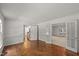 Bright living room featuring hardwood floors and glass french doors to another room at 10836 Wilmore Dr, Raleigh, NC 27614