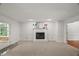 Cozy living room features a fireplace, and views of the backyard at 10836 Wilmore Dr, Raleigh, NC 27614