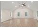 Spacious living room featuring hardwood floors, recessed lighting, and large windows at 10836 Wilmore Dr, Raleigh, NC 27614
