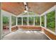 Bright sunroom featuring wood paneling, ceiling fan, and large windows at 10836 Wilmore Dr, Raleigh, NC 27614