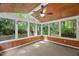 Bright sunroom with wood ceiling, ceiling fan, and multiple windows at 10836 Wilmore Dr, Raleigh, NC 27614