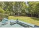 A spacious backyard includes a blue outdoor seating area and beautiful green lawn at 110 Duckwood Ln, Cary, NC 27518