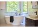Modern bathroom featuring a soaking tub, modern fixtures and a large window at 110 Duckwood Ln, Cary, NC 27518