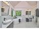 Bathroom with double sinks, large tub, glass enclosed shower and natural light at 110 Duckwood Ln, Cary, NC 27518