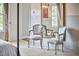 Bedroom seating area featuring chairs and a mirror reflecting natural light at 110 Duckwood Ln, Cary, NC 27518