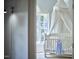Bedroom view with a crib draped with white cloth, plus a baby dress and a nearby window at 110 Duckwood Ln, Cary, NC 27518