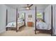 Bedroom featuring two beds, neutral walls and carpet, ceiling fan, and natural light at 110 Duckwood Ln, Cary, NC 27518