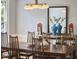 Charming dining room featuring a wood table, modern chandelier, mirror and decorative accents at 110 Duckwood Ln, Cary, NC 27518