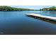 Dock on a calm lake surrounded by lush greenery, perfect for enjoying a peaceful moment at 110 Duckwood Ln, Cary, NC 27518