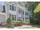 Close-up shot of a two-story home featuring large windows, trimmed hedges, and a well-manicured lawn at 110 Duckwood Ln, Cary, NC 27518