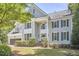 Beautiful home with a manicured lawn, trimmed hedges, black shutters, and a two-car garage at 110 Duckwood Ln, Cary, NC 27518