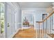 Spacious foyer featuring hardwood floors, white trim, and views of the dining room at 110 Duckwood Ln, Cary, NC 27518