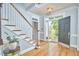 Bright foyer features hardwood floors, a staircase, and a glass-paneled front door at 110 Duckwood Ln, Cary, NC 27518