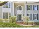 Inviting front entrance featuring large windows, trimmed hedges, and a brick stairway at 110 Duckwood Ln, Cary, NC 27518