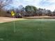 Scenic view of the golf course with a large green and a yellow flag at 110 Duckwood Ln, Cary, NC 27518