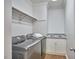 A well-lit laundry room with a modern washer and dryer and granite countertop at 110 Duckwood Ln, Cary, NC 27518