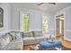 Comfortable living area featuring a large sectional couch, hardwood floors, and ample natural light at 110 Duckwood Ln, Cary, NC 27518