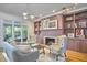 Bright living room with a cozy fireplace, custom built-in shelving, and stylish furnishings at 110 Duckwood Ln, Cary, NC 27518
