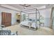 Serene main bedroom featuring a four-poster bed, hardwood floors, and en-suite bathroom access at 110 Duckwood Ln, Cary, NC 27518