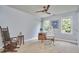 Office with neutral walls and carpet, plus a rolling desk chair and a rocking chair at 110 Duckwood Ln, Cary, NC 27518