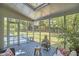 A cozy screened porch boasts a fire pit and views of the lush backyard at 110 Duckwood Ln, Cary, NC 27518
