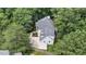 Aerial view of home showcasing new roof, private driveway, and backyard patio surrounded by mature trees at 12 Gatesway Ct, Durham, NC 27707