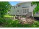 The backyard boasts a patio with a fire pit and seating, with stairs leading to a deck and upper level at 12 Gatesway Ct, Durham, NC 27707