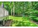 Lush backyard with a swing set and mature trees, perfect for outdoor activities at 12 Gatesway Ct, Durham, NC 27707