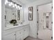 Bright bathroom with double sink vanity, framed mirror, and doorway to a walk-in closet at 12 Gatesway Ct, Durham, NC 27707