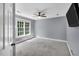Bedroom featuring neutral paint, fan, wall-mounted television, and a window with natural light at 12 Gatesway Ct, Durham, NC 27707