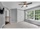 Bedroom featuring neutral paint, closet, fan, a window with natural light, and a side door at 12 Gatesway Ct, Durham, NC 27707