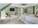 Large bedroom features a ceiling fan, two windows with backyard views, and soothing light-green walls at 12 Gatesway Ct, Durham, NC 27707