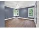 Bedroom with blue walls, hardwood floors, crown molding, a fan, and natural lighting at 12 Gatesway Ct, Durham, NC 27707