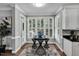 Bright breakfast nook with plantation shutters and modern furnishings adjacent to the kitchen at 12 Gatesway Ct, Durham, NC 27707