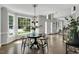 Bright dining room featuring hardwood floors, natural light, and a modern light fixture at 12 Gatesway Ct, Durham, NC 27707