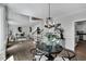 An open floor plan featuring a modern chandelier above a dining table and a staircase in the background at 12 Gatesway Ct, Durham, NC 27707