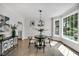 Dining room with hardwood floors, natural light, and a modern light fixture at 12 Gatesway Ct, Durham, NC 27707