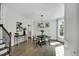 Bright dining room boasts hardwood floors, wainscoting, and a modern chandelier at 12 Gatesway Ct, Durham, NC 27707