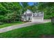 Well-maintained home featuring a lush green lawn and a long private driveway at 12 Gatesway Ct, Durham, NC 27707