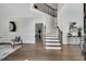Bright foyer featuring hardwood floors, a staircase, and elegant decor at 12 Gatesway Ct, Durham, NC 27707